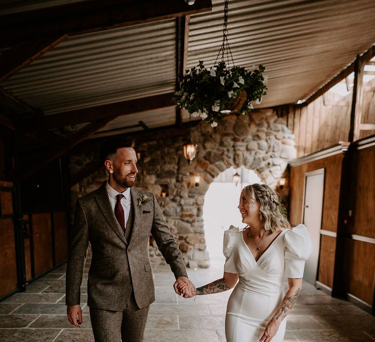 Groom in grey tweed suit with the bride in a statement puff sleeve wedding dress 