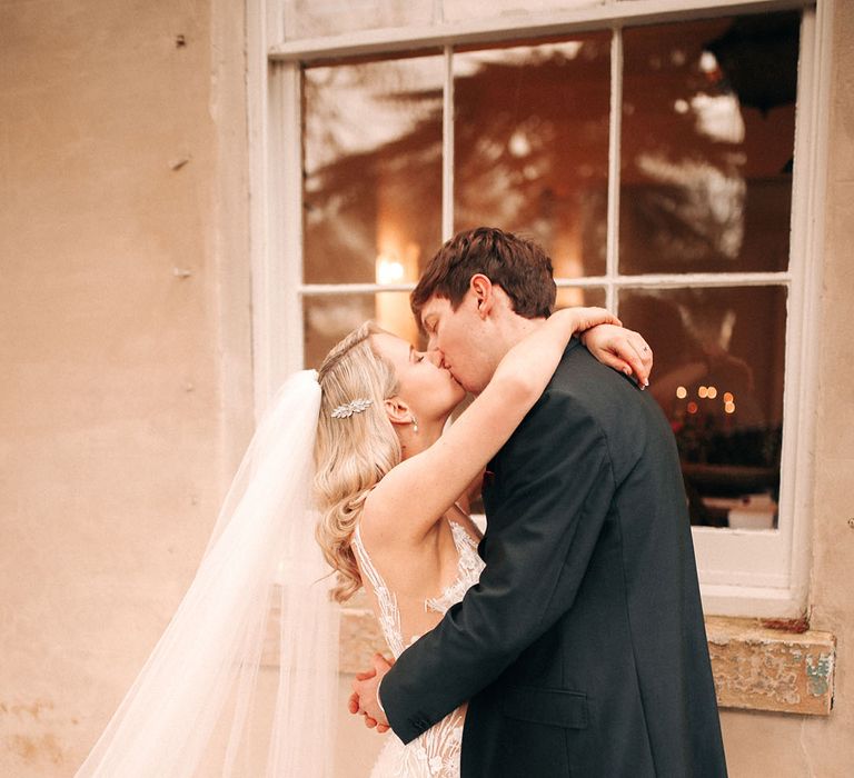 The bride and groom share a kiss for their wedding day to celebrate 