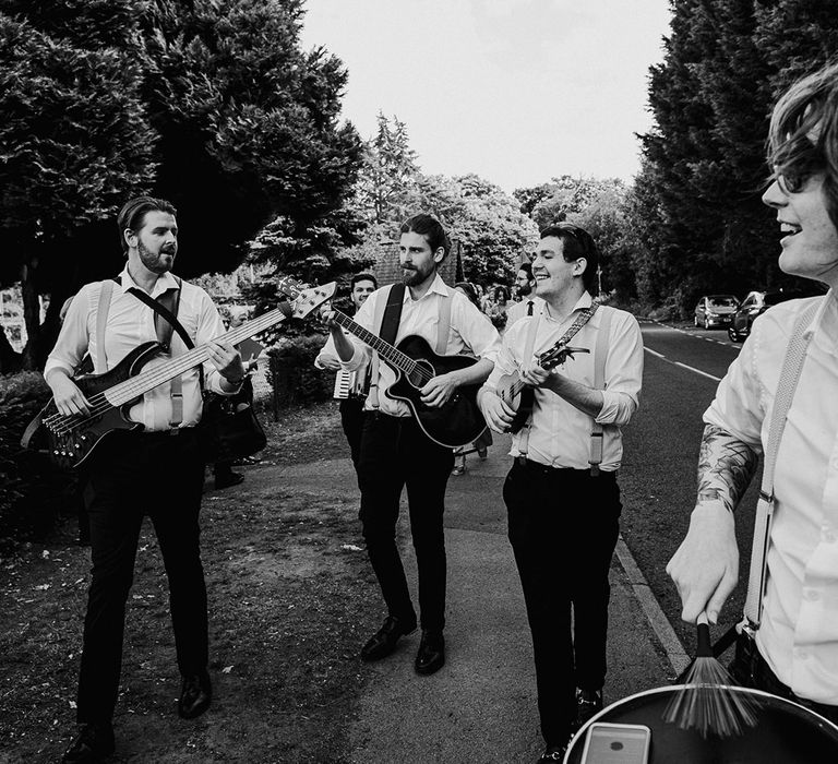 Roaming wedding band in white shirt and patterned braces 