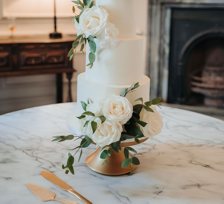 White three tier iced wedding cake with personalised cake topper 