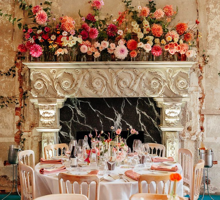 Pink wedding theme with pink wedding flowers on the fireplace and the tablescapes 