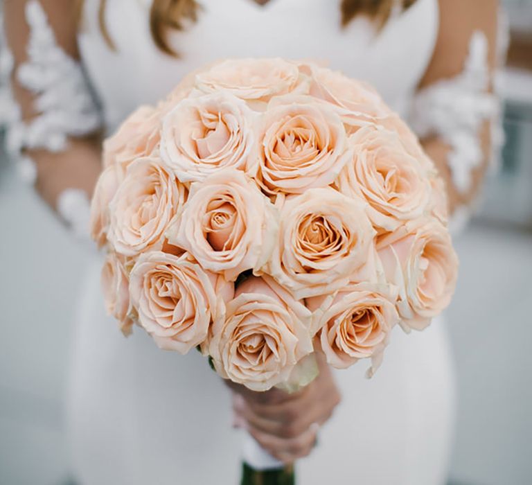 Round rose wedding bouquet with flowers in peach tone 