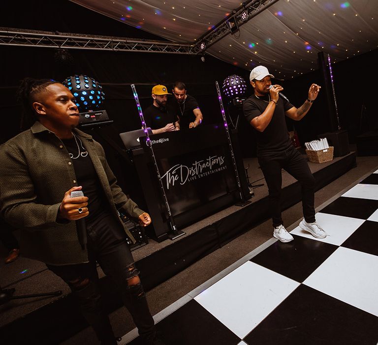 Distraction wedding band performing on classic black and white checkered dance floor 