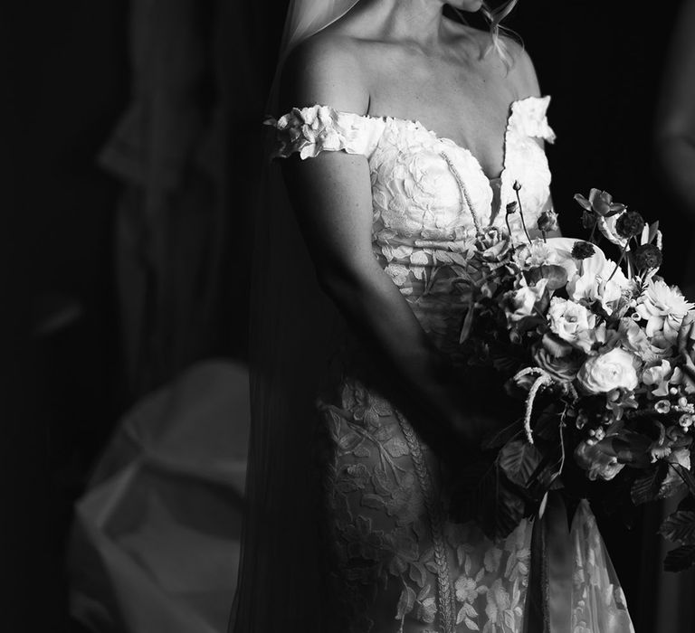 Bride in off the shoulder wedding dress with neutral flower wedding bouquet 