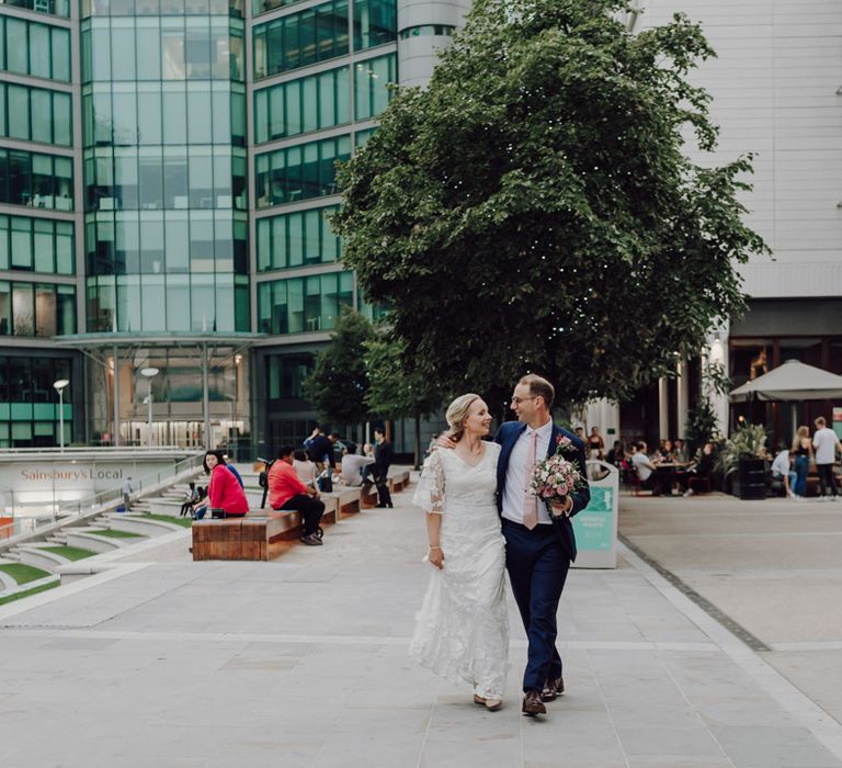 Bride and groom at city wedding with London wedding bus