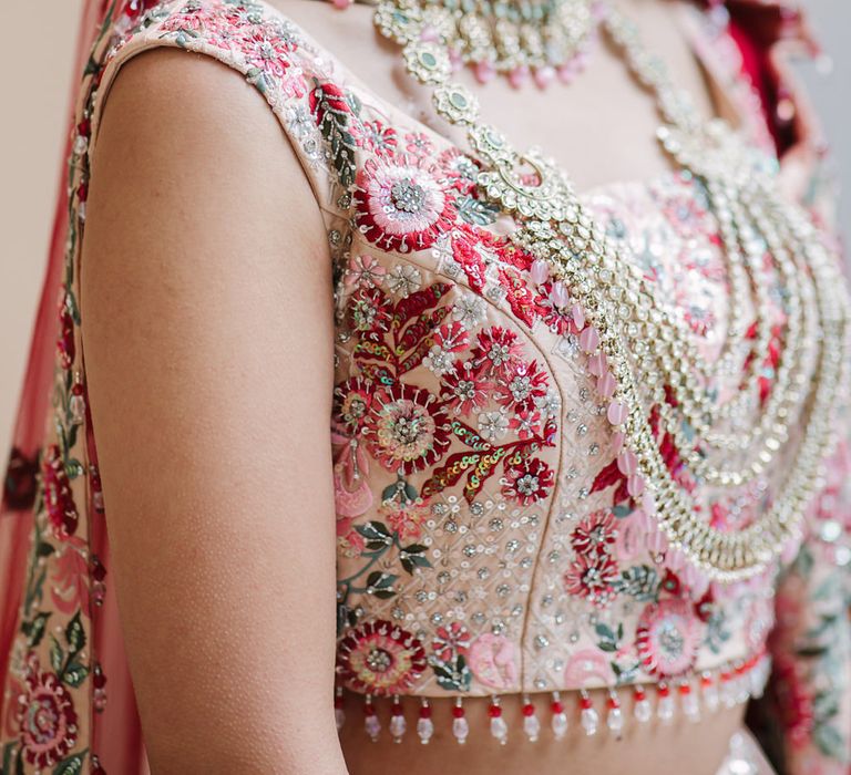 Indian bride in a pink embroidered bridal bandeau and Mangala Sutra necklace 