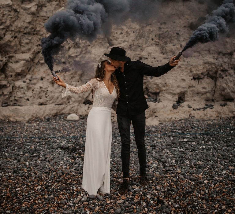 Blue smoke bomb portrait on the beach 