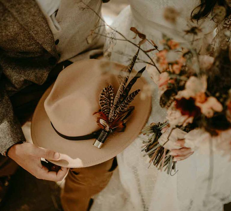 The groom's hat feathers are from Lilly Dilly's