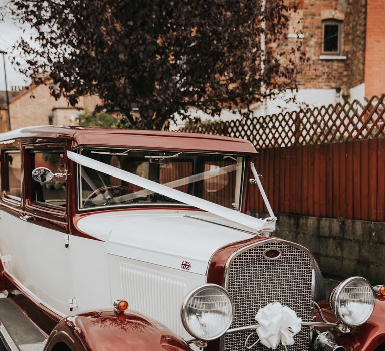 Vintage wedding car complete with white ribbon 