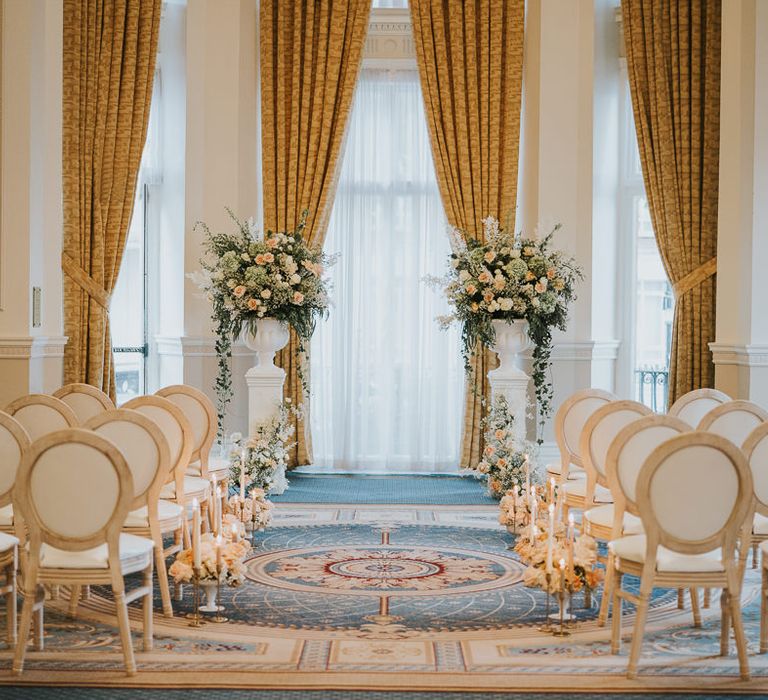 Intimate wedding ceremony set up in the Empire Room at The Landmark London with blush floral arrangements