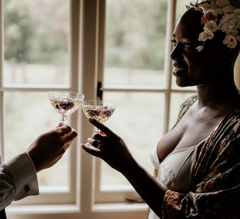 Bride and groom toasting on the wedding morning with coupe glasses 