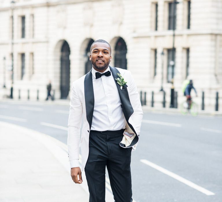 Groom walks wearing monochrome tux through London