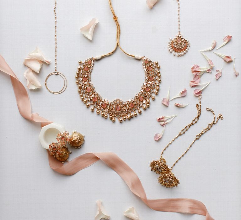 Gold jewellery featuring necklace and headwear 