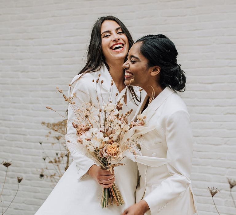 Two brides at their all white wedding at La Fabrique Evenementielle