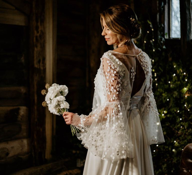 Bride wearing bespoke embroidered bell sleeve wedding dress by Delphine Couture for rustic luxe wedding