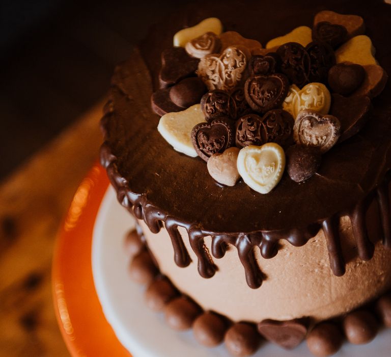 Chocolate wedding cake with chocolate fondant dripping along the outside 