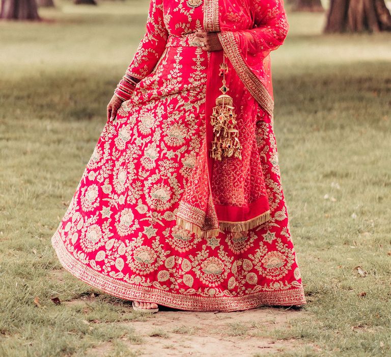 Bride twirls around wearing brightly coloured Lengha on the day of her wedding