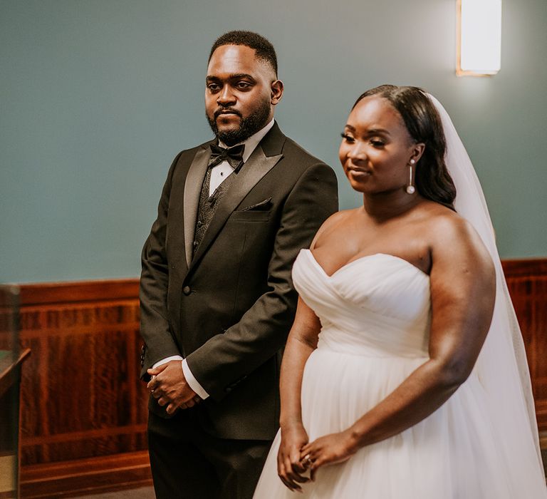 Bride & groom stand at the altar during their wedding ceremony