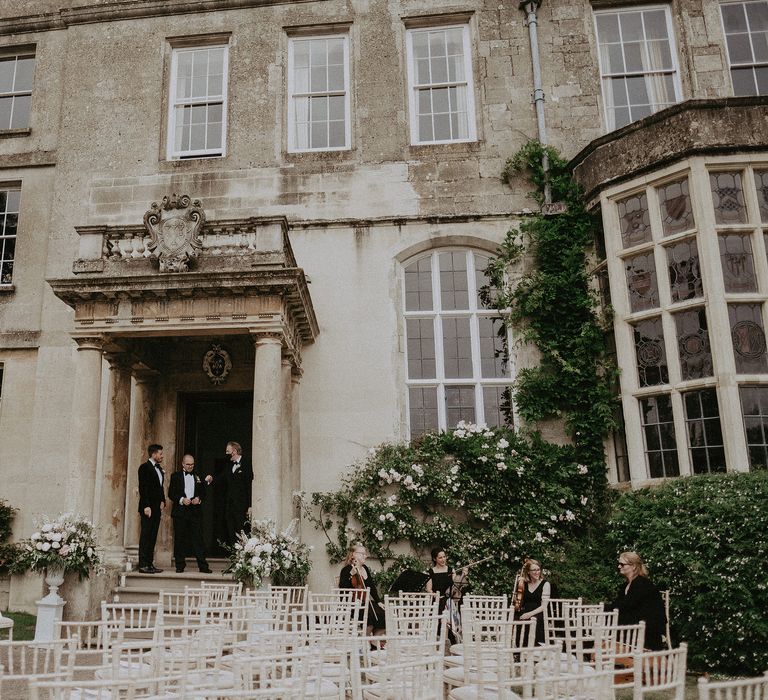 Elmore Court ready for wedding ceremony with chairs lining outdoor aisle in front of large doorway and historic building