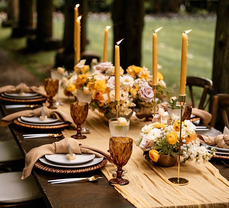 Yellow taper candles, wedding flowers and table runner for honey yellow wedding inspiration