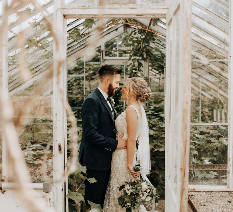 Greenhouse wedding portrait for bride and groom