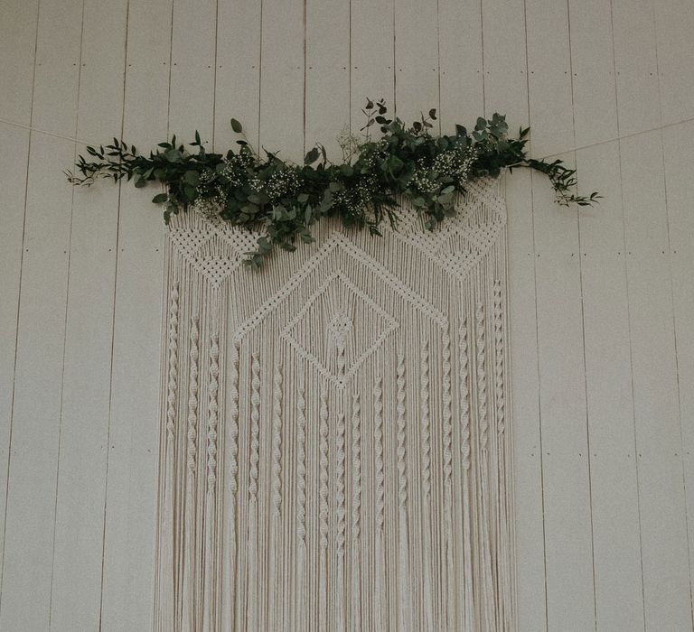 Large macrame hanging with green foliage top for Isle of Wight wedding with macrame wedding decor