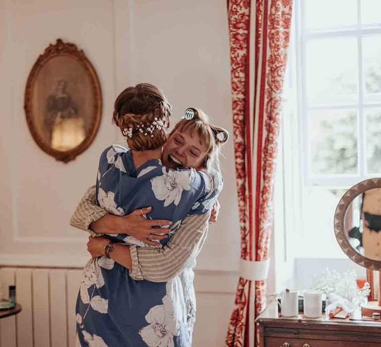 Bride celebrates with friend as she gets ready