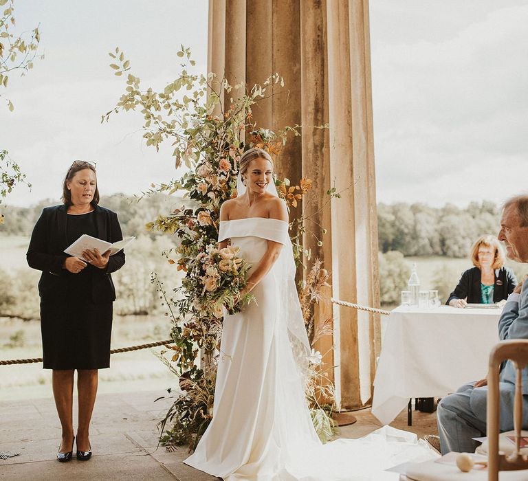 Bride looks to her side on her wedding day during ceremony