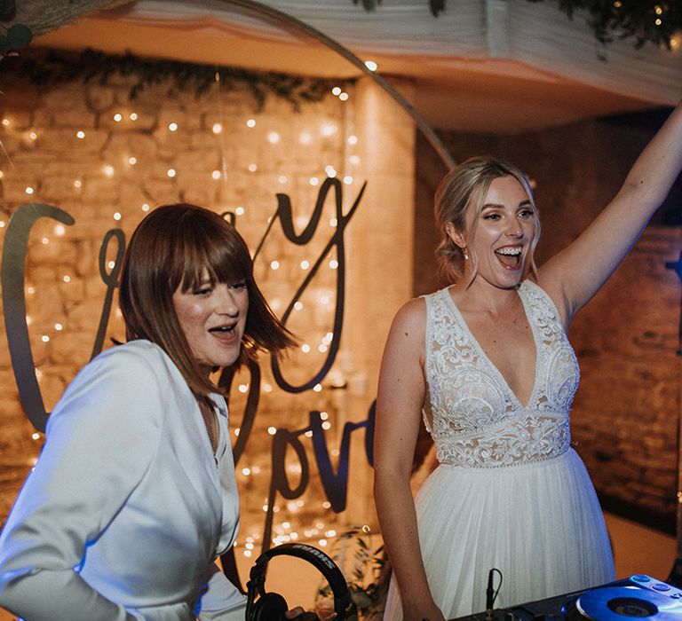 Brides dance as they DJ at The Great Tythe Barn wedding