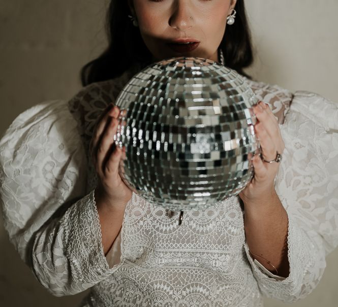 Bride holds disco ball