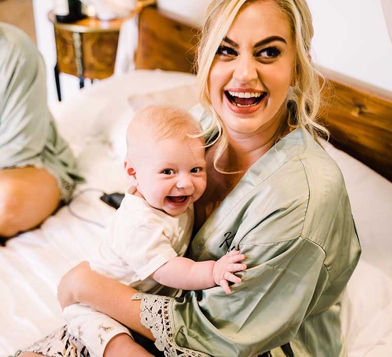 Bridesmaid holds baby 