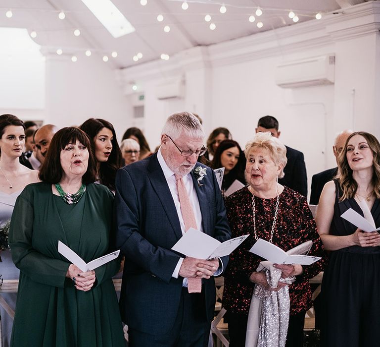 Wedding guests await brides arrival 