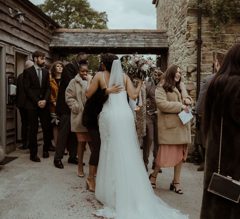 Bride hugs wedding guest on her wedding day