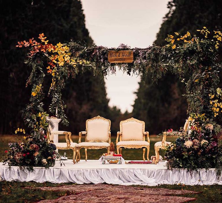 Unique flower arch with a pop of yellow at Indian wedding at Minley Manor