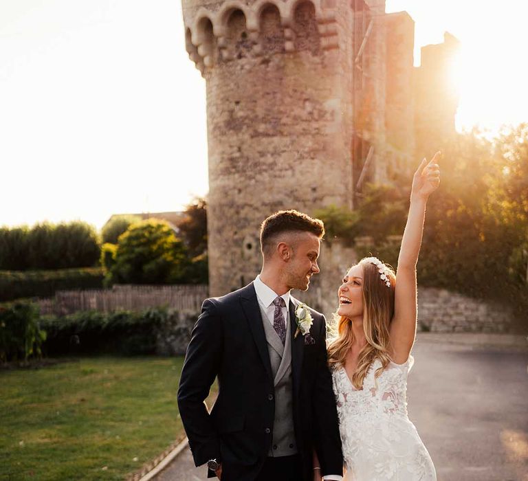 Bride in lace wedding dress and groom in three piece suit at Cooling Castle wedding venue