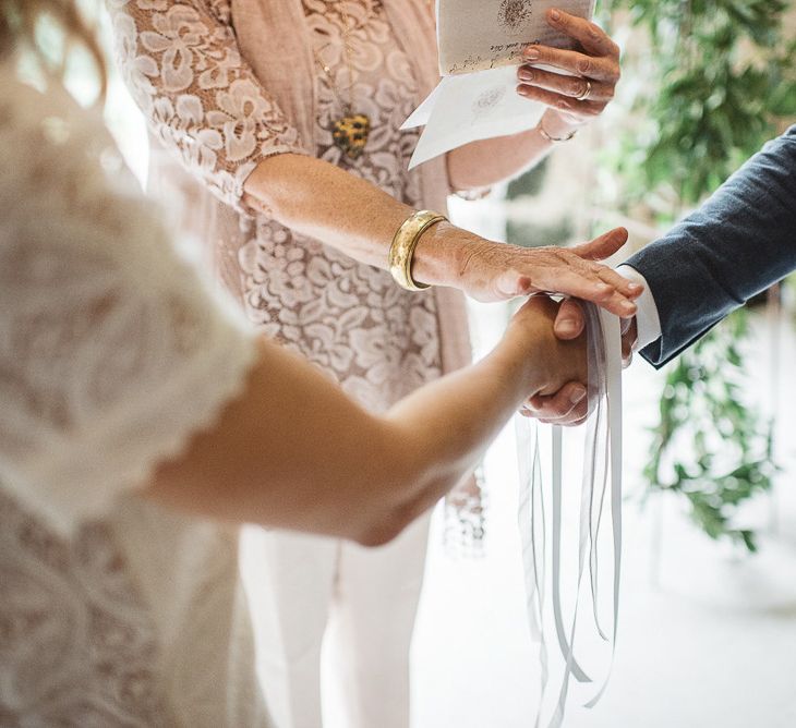 Rustic French wedding with handfasting ceremony with white ribbon