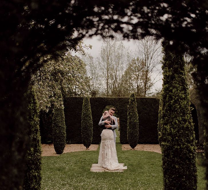 Bride & groom during intimate first dance moment outdoors in manicured gardens of Oxleaze Barn