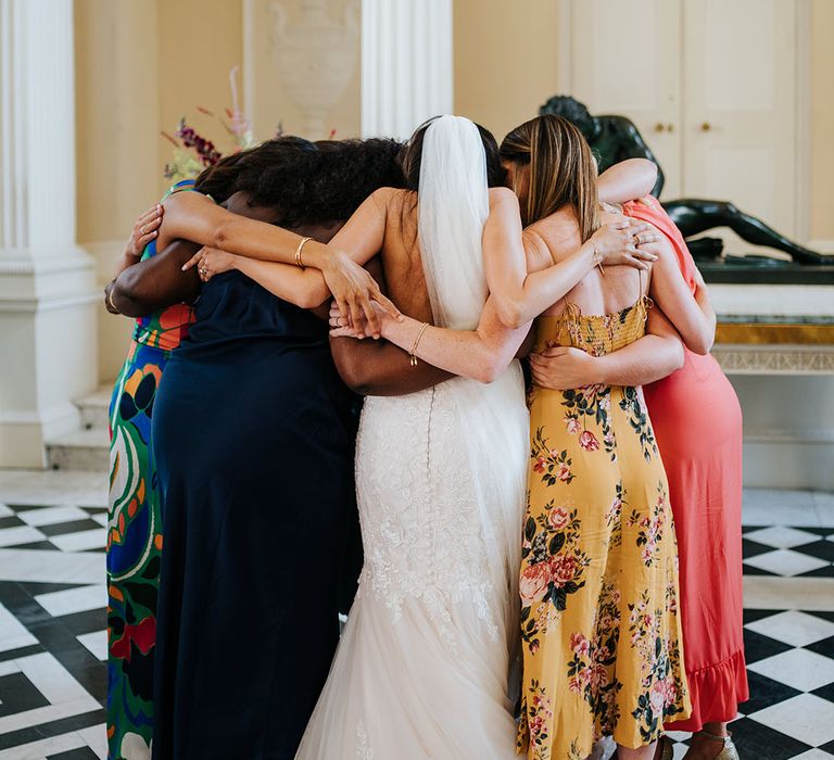 Bride hugs her A Capella group after wedding ceremony