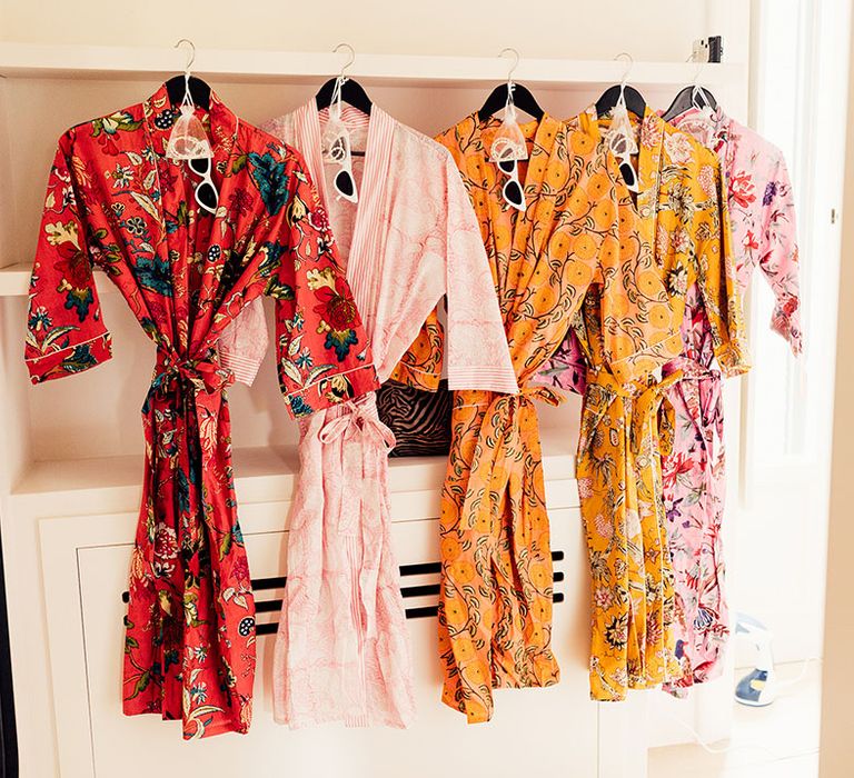 Colourful patterned bridesmaid robes with white cat eye sunglasses and jewellery 