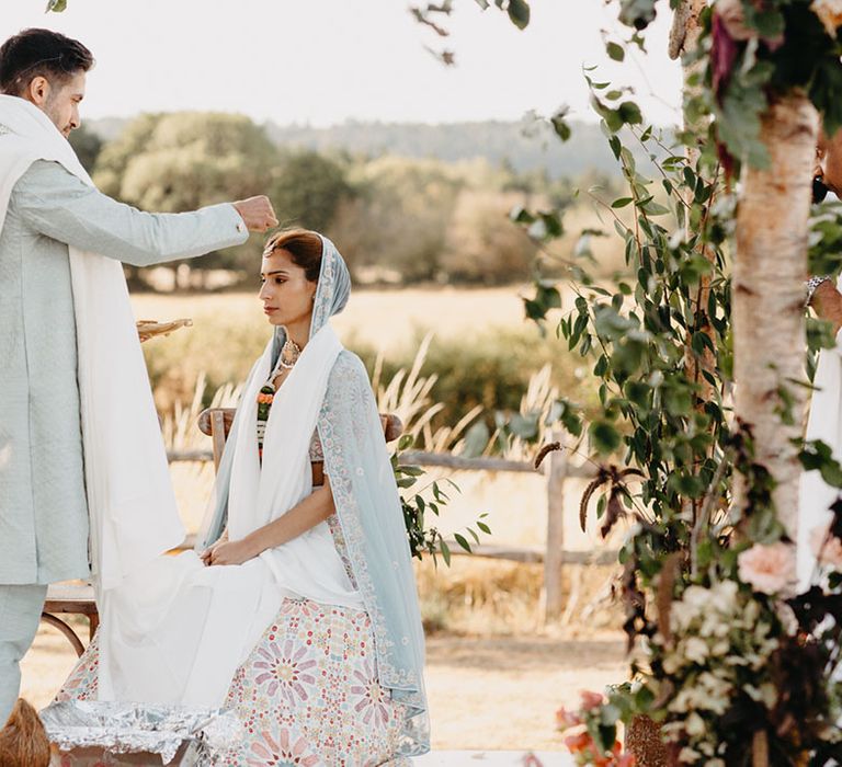 Bride & groom during traditional Indian ceremony at High Billinghurst Farm for outdoor wedding