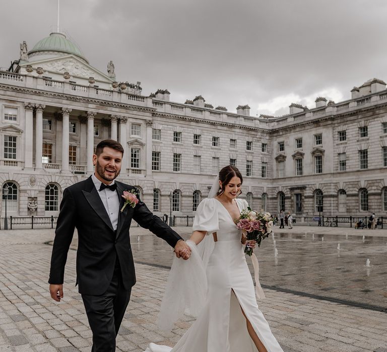 Bride and groom hand in hand at Somerset House wedding