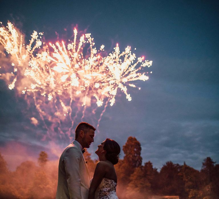 The bride and groom watch their surprise fireworks 