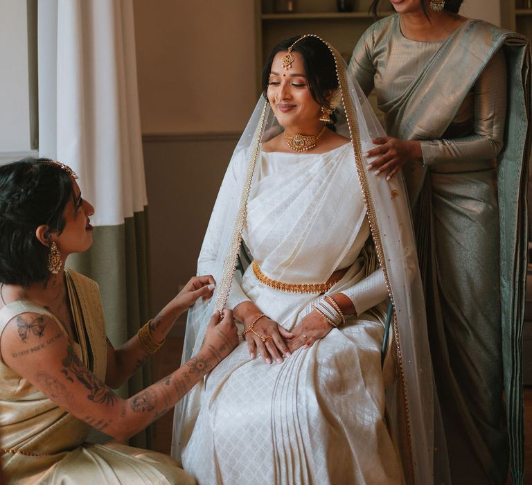 Morning of the wedding with South Asian bride in a cream and gold lehenga 