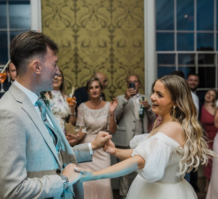 The bride and groom share their first dance together at their classic British wedding 