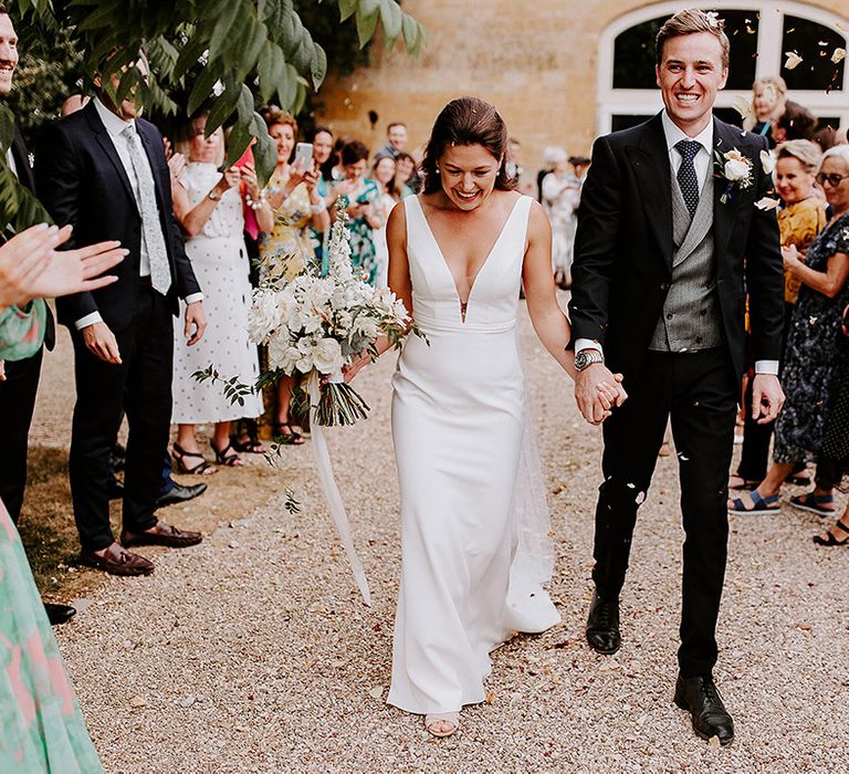 Confetti exit for the bride and groom as they walk out of their civil wedding ceremony 