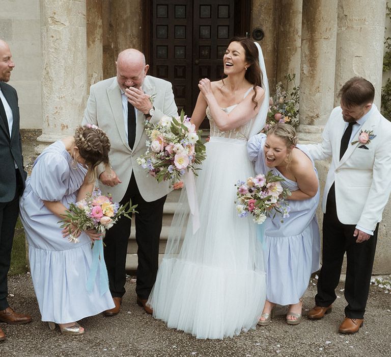 Wedding party in blue and cream wedding outfits for the spring April wedding 