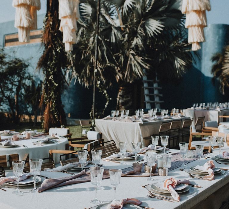 White wedding tablescapes with dusty pink table runners and tassel lampshades at Tigre Del Mar wedding reception