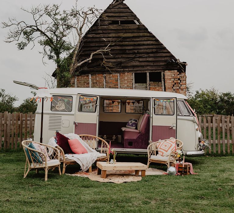 VW Campervan wedding transport opened up to make a seating area at the boho festival wedding 