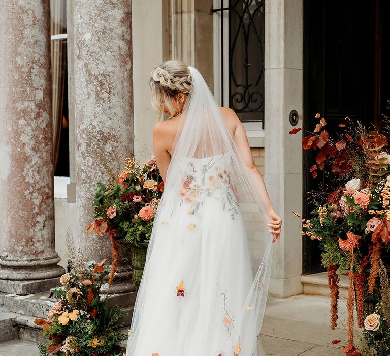 Bride in bespoke autumn leaf embroidered wedding dress and veil 