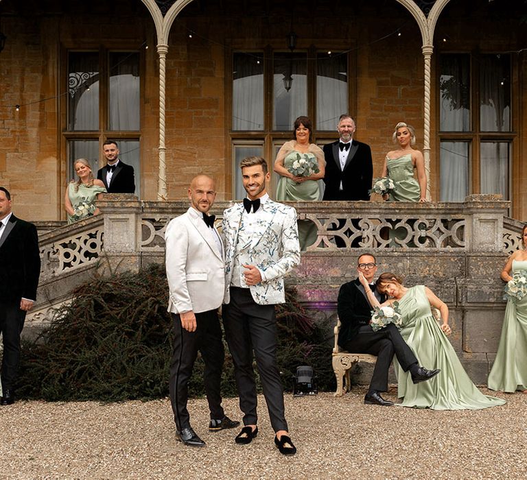 Wedding party with the bridesmaids wearing green bridesmaid dresses and groomsmen in suits 